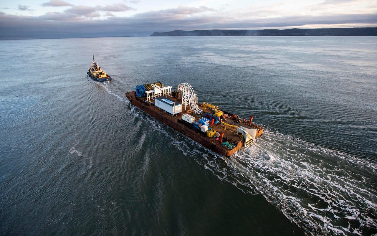 A barge is towed by a ship in the Minas Passage of Nova Scotia