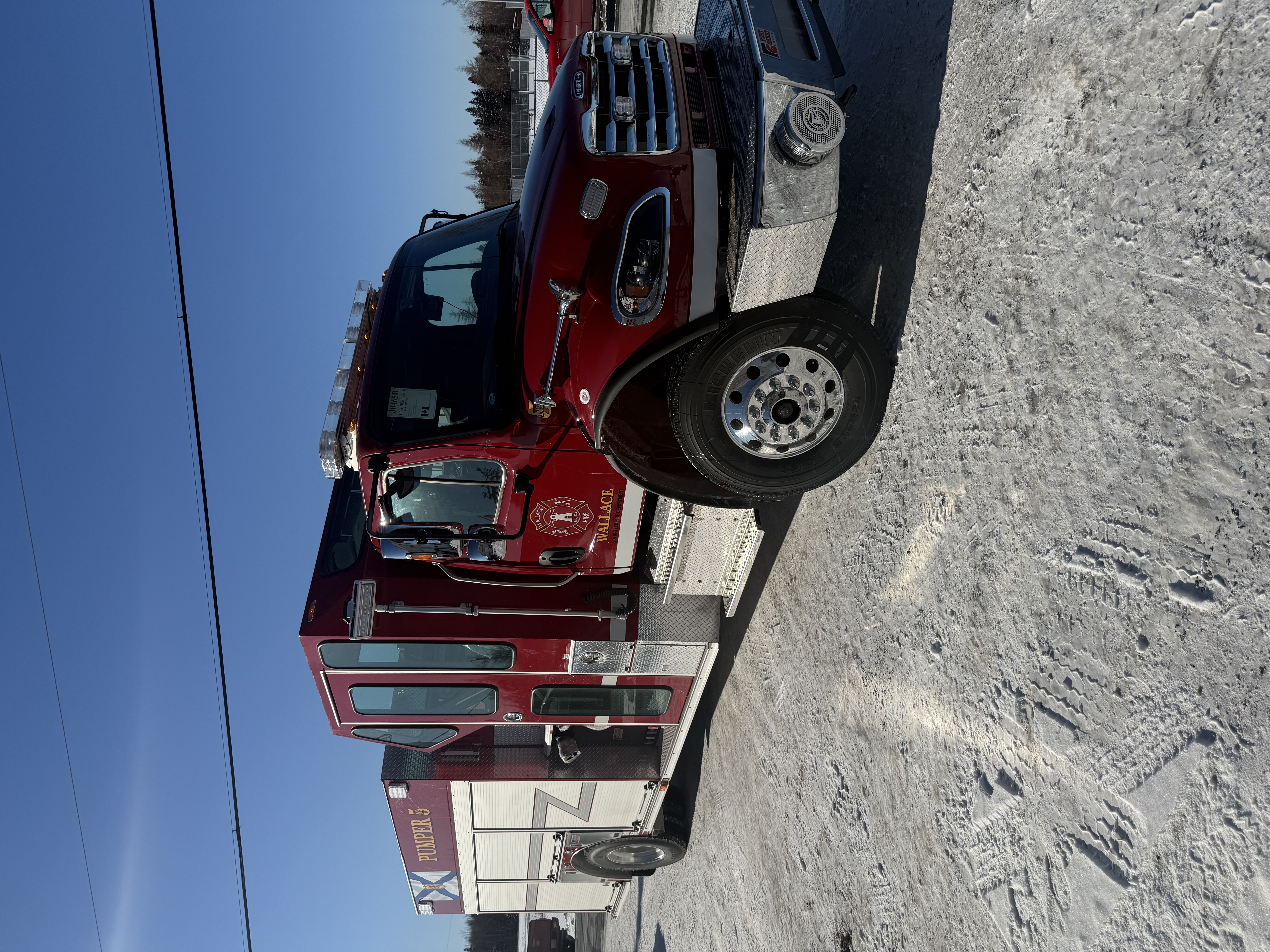 A red truck sits in a parking lot