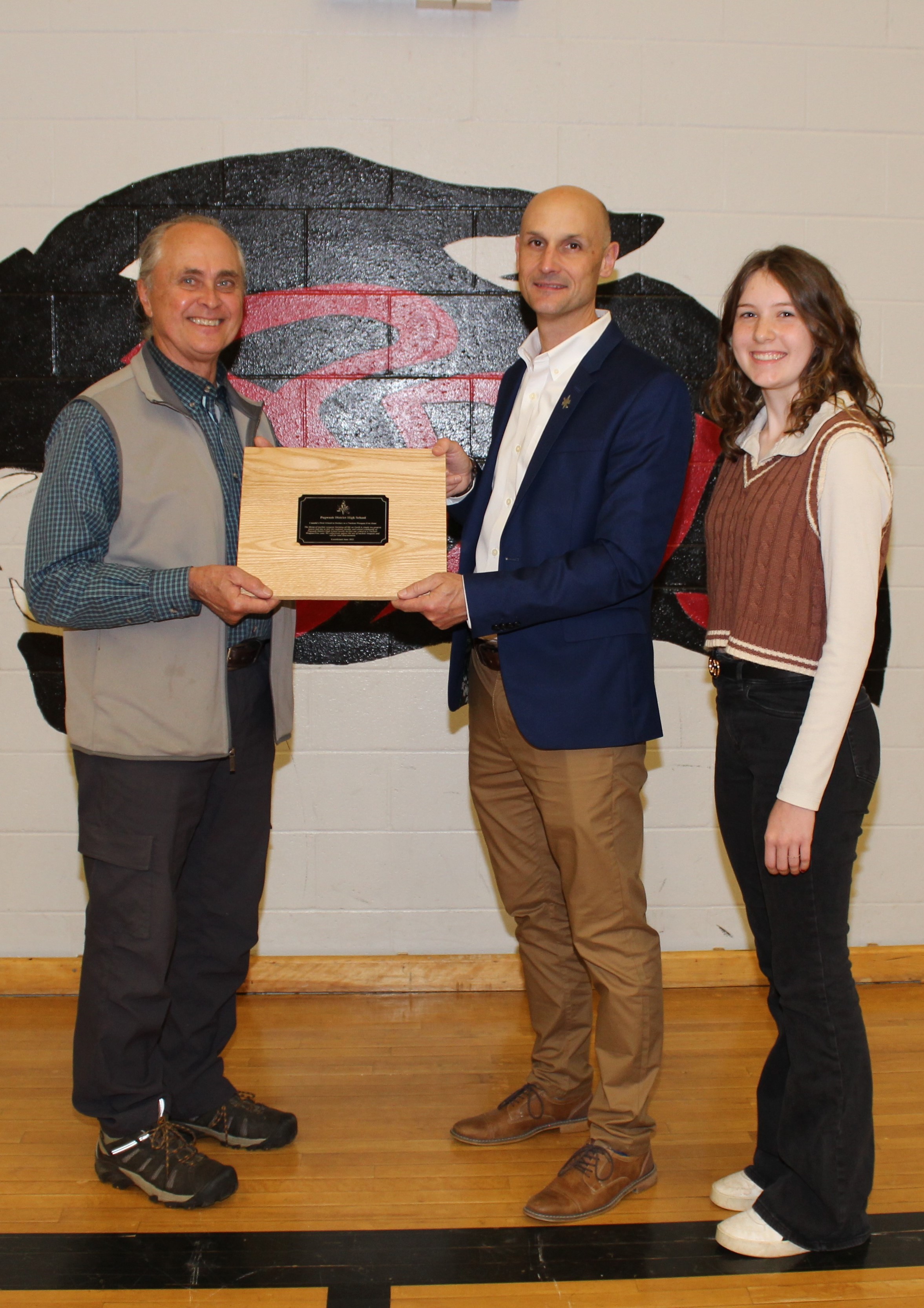 (From left) Robert Cervelli from the Centre for Local Prosperity, principal Shawn Brunt and student council president Madi Allen hold the plaque declaring Pugwash District High School as a nuclear-weapon-free school. 