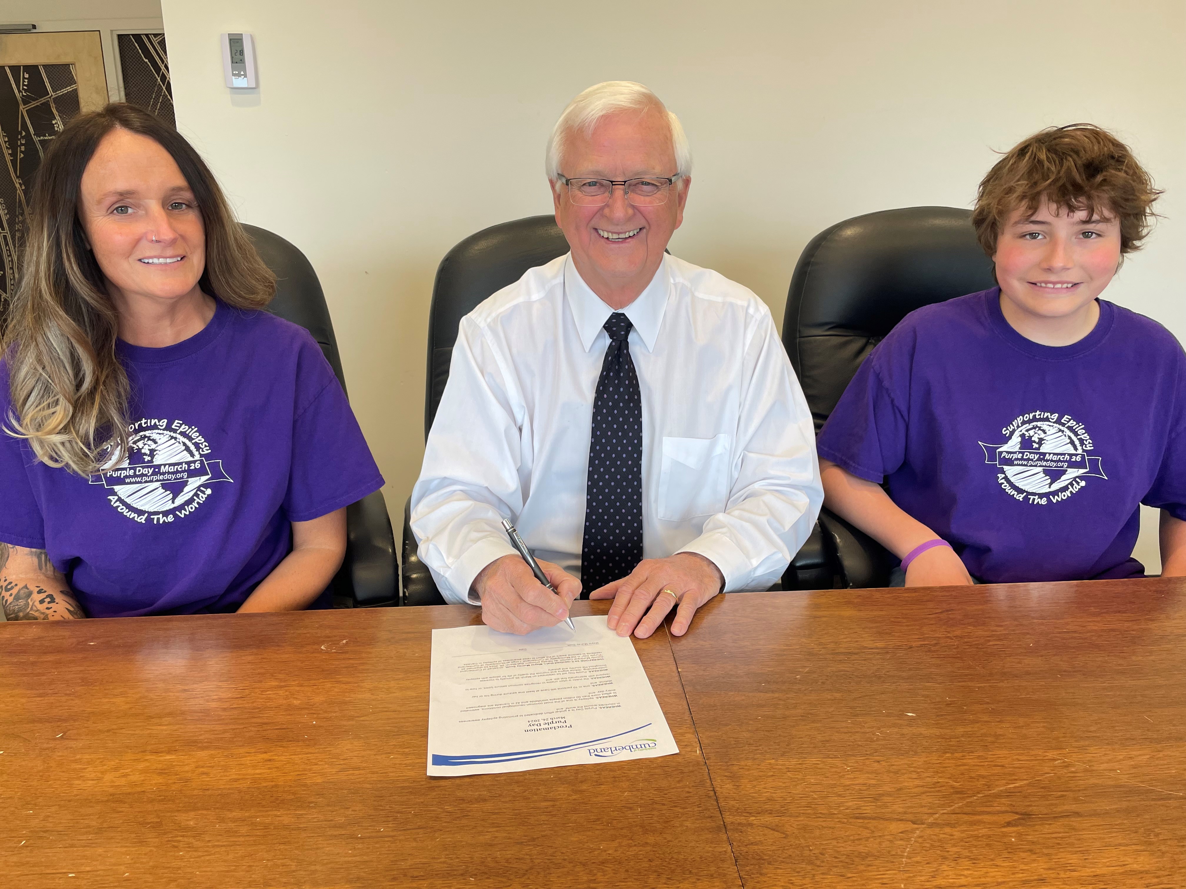 Mayor Murray Scott signs a proclamation declaring March 26 as Purple Day in the Municipality of Cumberland.